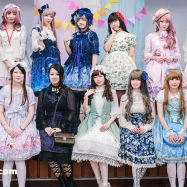 A group of people dressed in elegant and colorful Lolita fashion outfits, posing together.